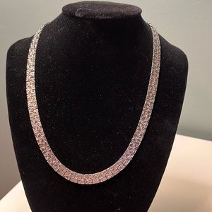N78. Flat silver colored necklace.